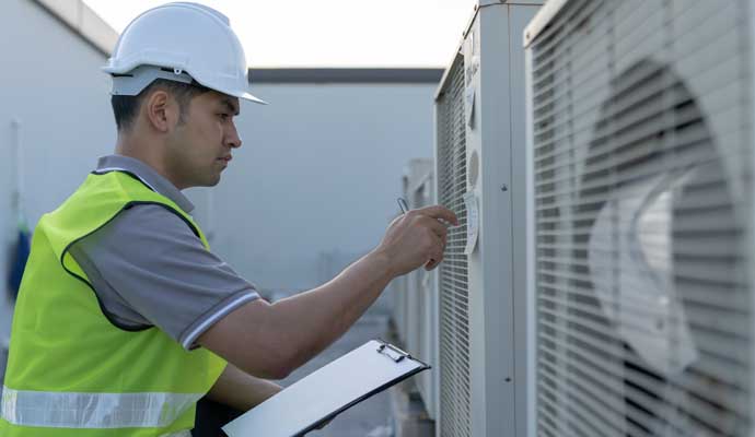 Professional inspecting  an AC