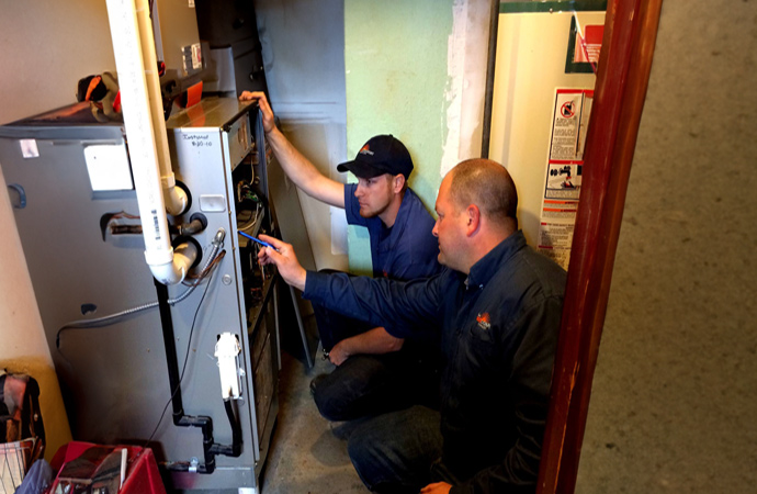 professionals-repairing-malfunctioned-furnace-parts.jpg